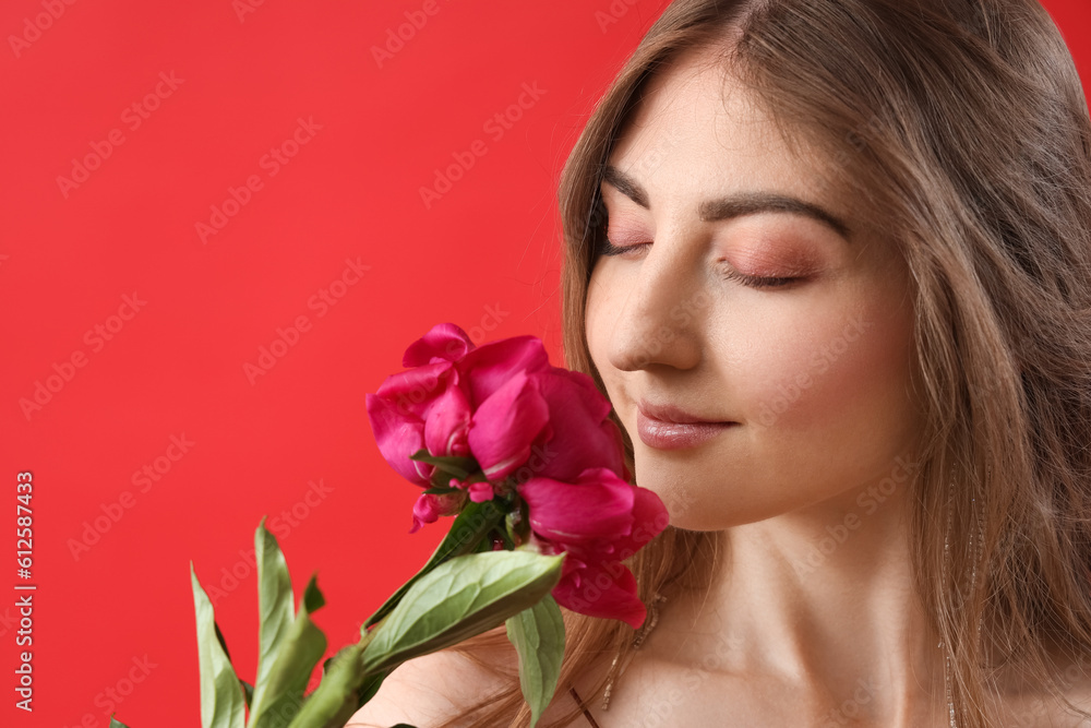 Beautiful young woman with peony flower on red background Beautiful young woman with peony flower on red background