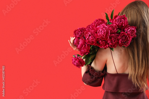 Young woman with bouquet of...