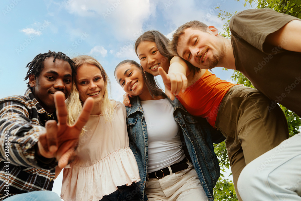 portrait of a multiracial group of friends looking at the camera and making gestures. Friendship and togetherness. Young people having a good time. portrait of a multiracial group of friends looking at the camera and making gestures. Friendship and togetherness. Young people having a good time.
