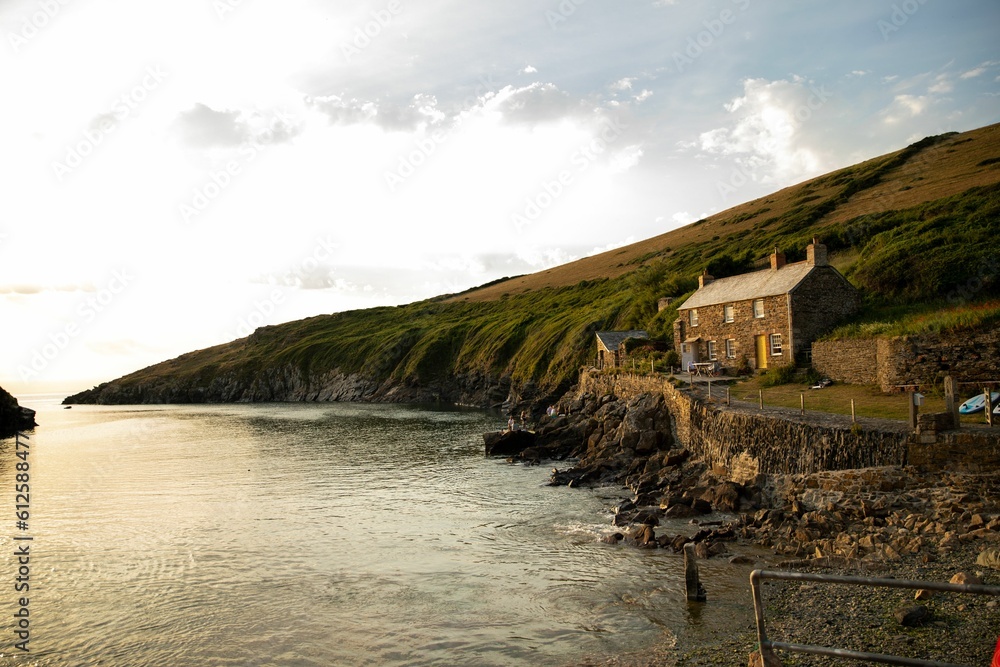 Drone shot of a stone house on the rocky coast of a sea, cool for background