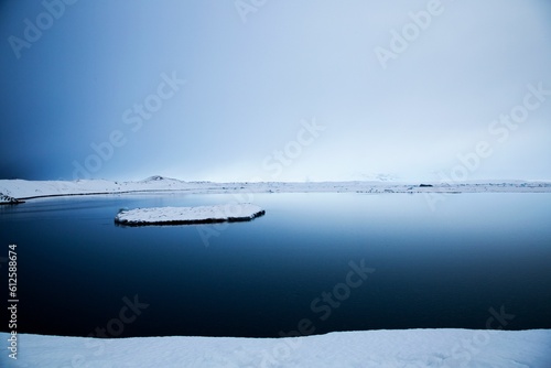 Beautiful shot of a clear blue lake with a patch of ice in Iceland © Jos Vanaubel/Wirestock Creators
