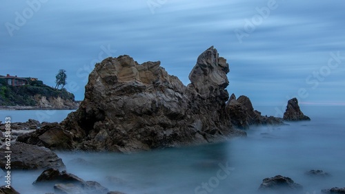 Scenic view of a seascape with rocks and sky after sunset with long exposure © Matt Johner/Wirestock Creators