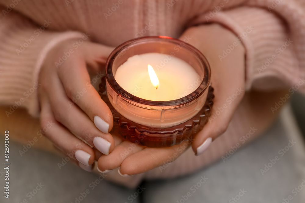 Woman with beautiful burning candle, closeup Woman with beautiful burning candle, closeup