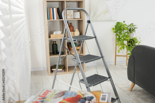 Metal folding ladder in stylish living room