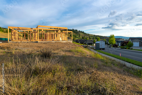 Wall Mural A luxury home framed and under construction at a hillside subdivision of homes in a suburb of Spokane, Washington, USA