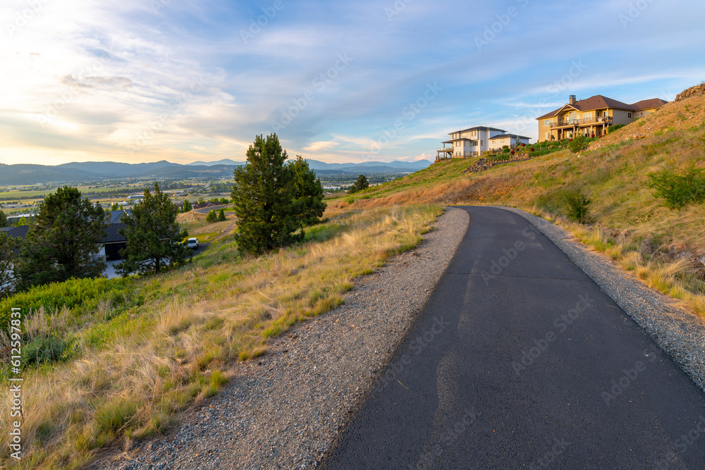 A hillside walking trail with luxury high end view homes overlooking the Spokane Valley in the city of Liberty Lake, Washington, a suburb of Spokane, Washington. A hillside walking trail with luxury high end view homes overlooking the Spokane Valley in the city of Liberty Lake, Washington, a suburb of Spokane, Washington.