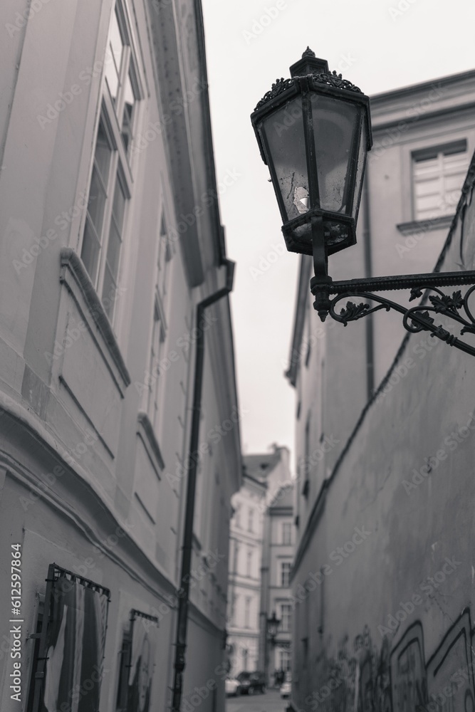 Vertical of a broken lantern on an ancient building wall