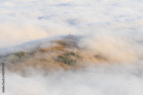 Aerial view of the mountains in the fog © Thomas Langmann/Wirestock Creators