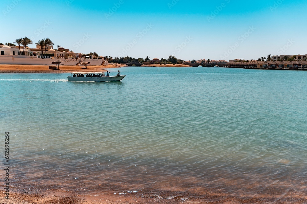 Boat with people riding in a lagoon in El Gouna, Red Sea, Egypt..