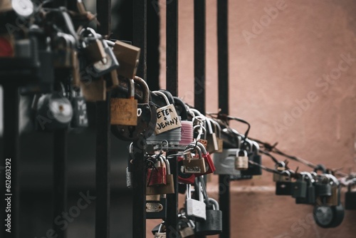 Closeup shot of a bunch of love locks hanging on a gate