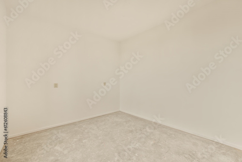 an empty room with white walls and no one wall in the room is visible on the right side of the photo