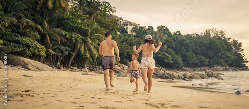Family running on the beach 