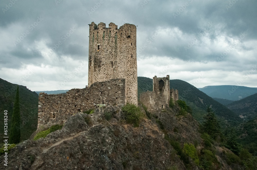 Ruins of the medieval Cathar Castles on top of the mountain in France against the cloudy sky