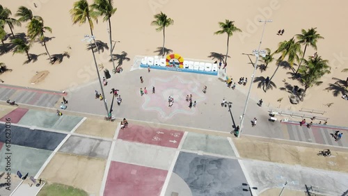 Aerial of people walking and resting on the sandy beach in Joao Pessoa Brazil photo
