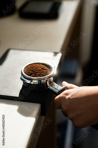 Barista making coffee in coffee shop. Barista brewing coffee.