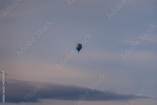 Scenic view of a hot air balloon floating in the air during a sunset
