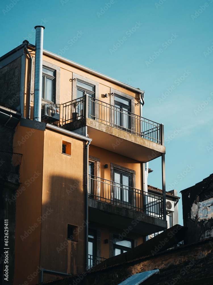 Couple of buildings with windows, a balcony, and balconies