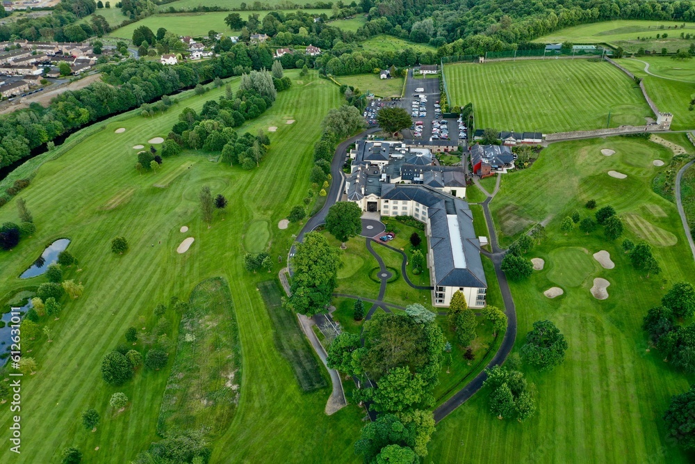 Fototapeta premium Aerial shot of lush green fields and houses
