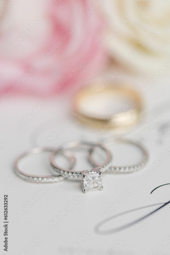 A closeup shot of diamond ring on a white surface A closeup shot of diamond ring on a white surface