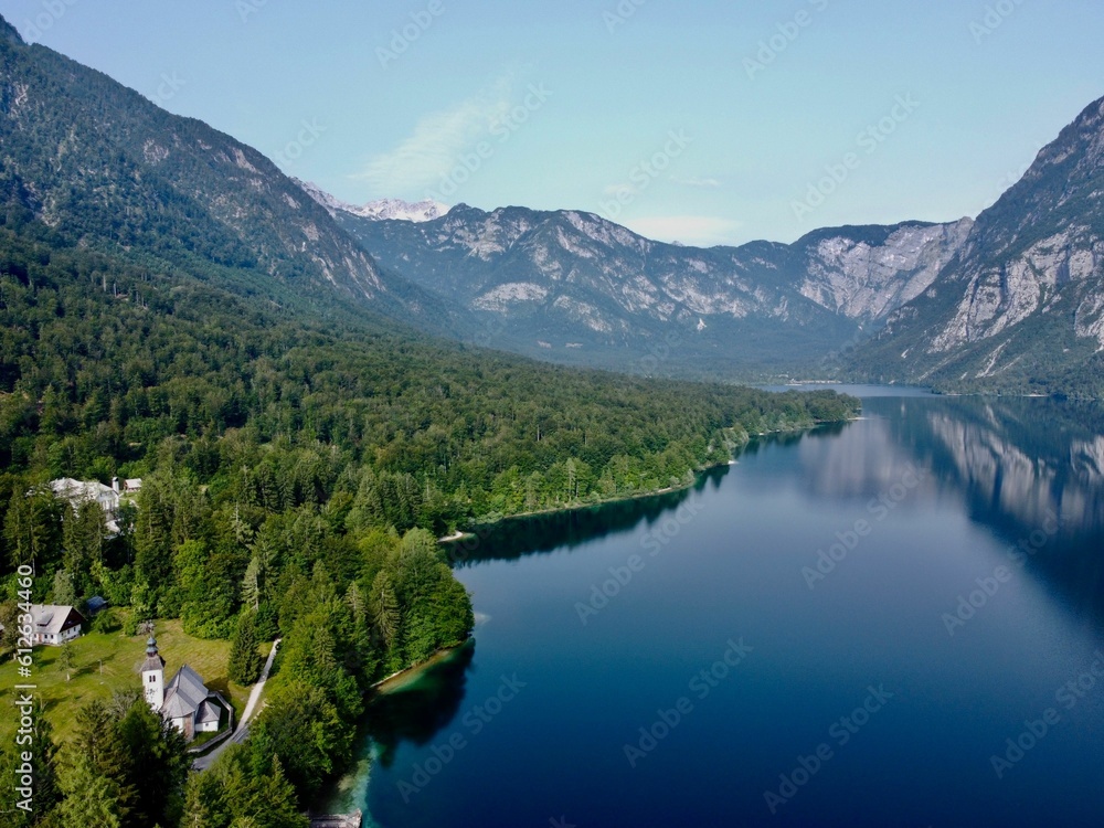 Idyllic view of a pristine lake and mountains in a tranquil forested area.