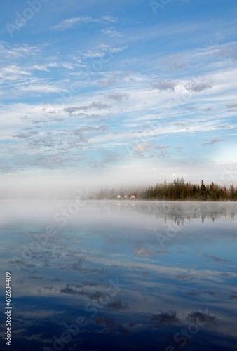 Vertical shot of a serene lake in a remote location, surrounded by nature