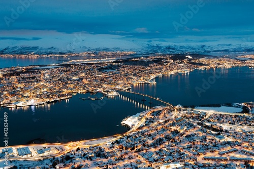 Aerial view of the city of Troms, Norway, illuminated by the night sky