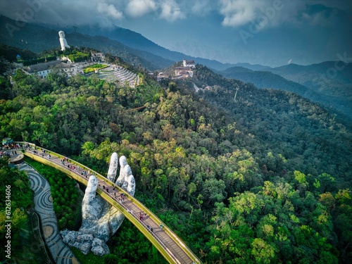 Aerial shot of the Golden bridge spanning a lush green valley in Vietnam. photo