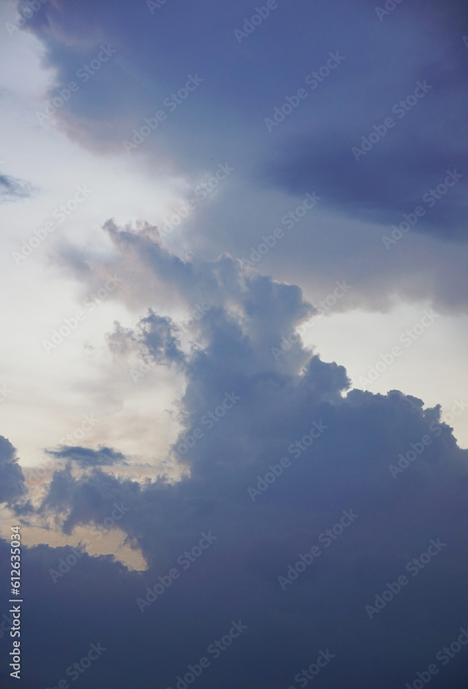 Background of gray cloudy sky layered with white cloud and sunlight