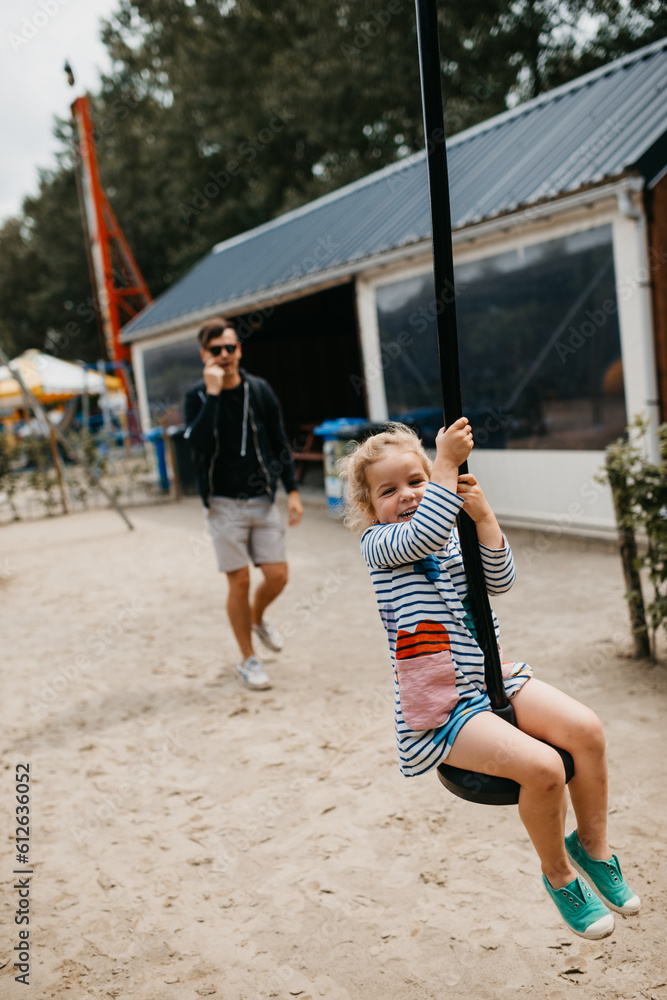 Girl enjoying a swing slide - death ride at a local playground Girl enjoying a swing slide - death ride at a local playground