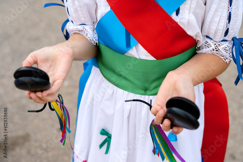 Girl with traditional costume holding castanets photo