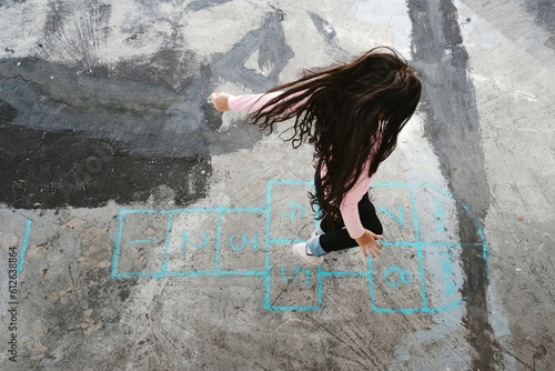 girl playing hopscotch
