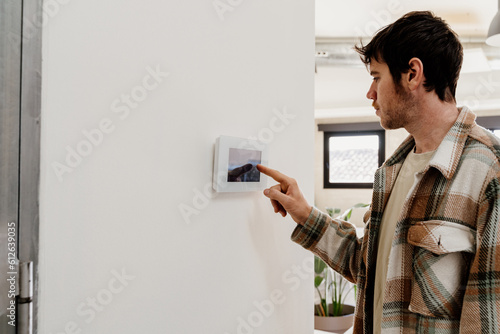man using smart panel device at home
