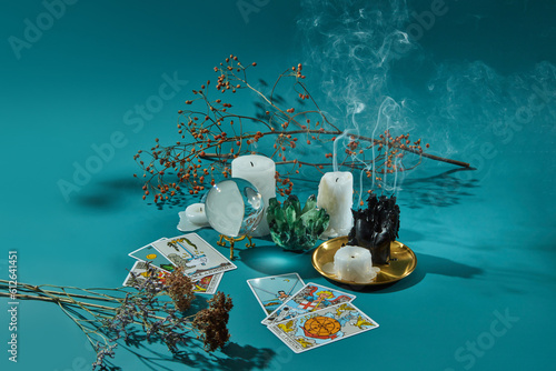 Tarot cards, glass sphere, candles, quartz and dry plants.