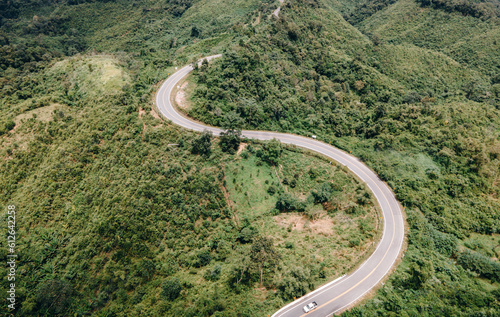 Aerial view of amazing road with green forest and mountain,Bird's eye view from drone