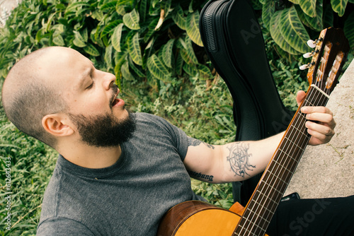 Man playing guitar in nature photo