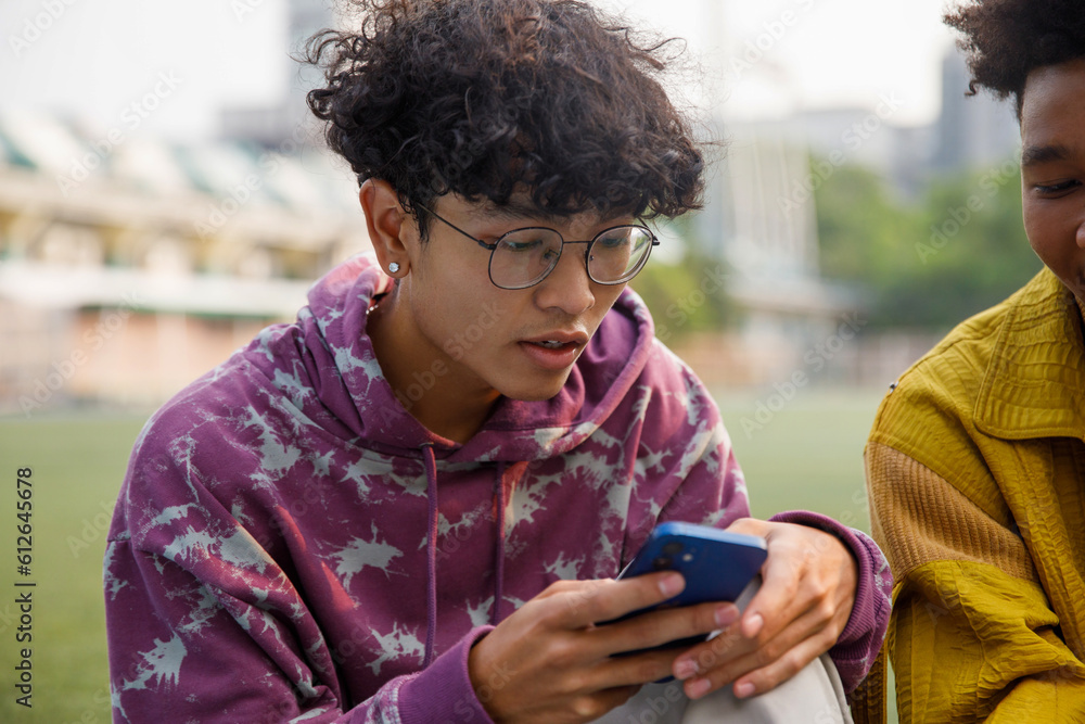 Asian teenager texting on smartphone Asian teenager texting on smartphone