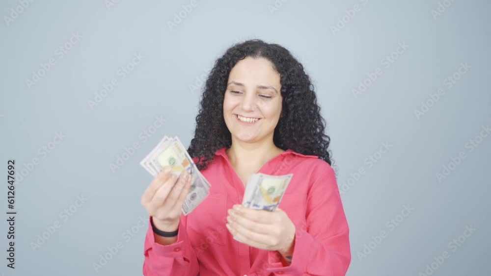 Young woman counting money looking at camera. Young woman counting money looking at camera.