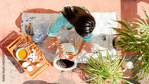 Overhead Shot Of A Woman Painting A Pot photo