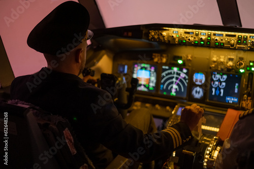 Caucasian bearded man controls the plane and looks at the beautiful sunset sky. 