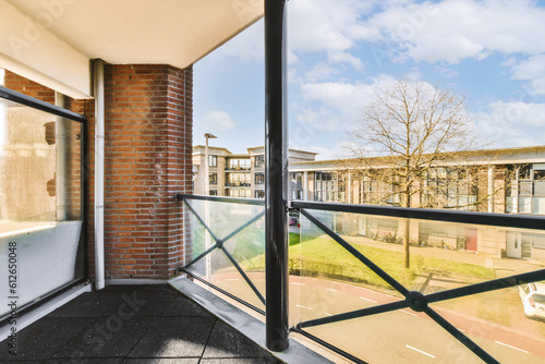 an outside area with brick walls and glass doors, looking out onto the street in front of the apartment building