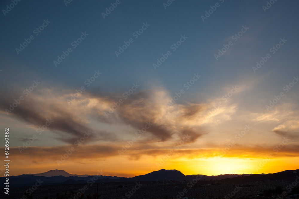 Mountain silhouettes of a golden desert sunset
