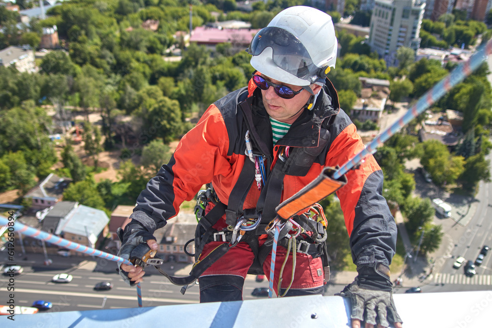 Fototapeta premium A specialist is repairing the roof. Rope access