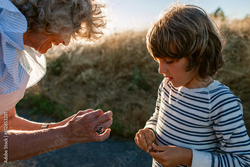 Grandma removes a splinter from her grandson 