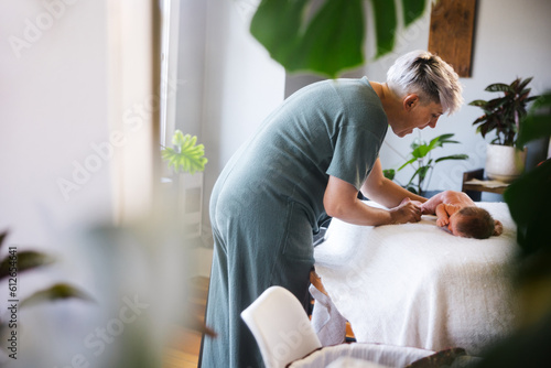 Mother changing newborn baby at home. photo