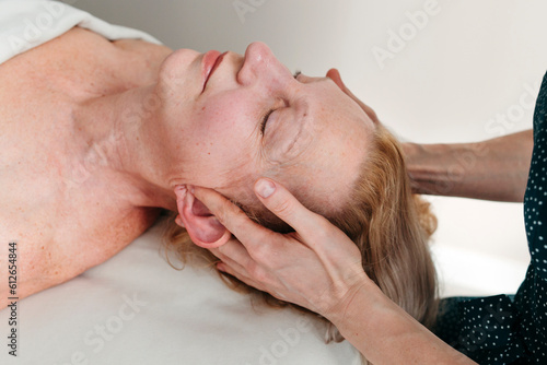 Matute woman having head massage at spa.