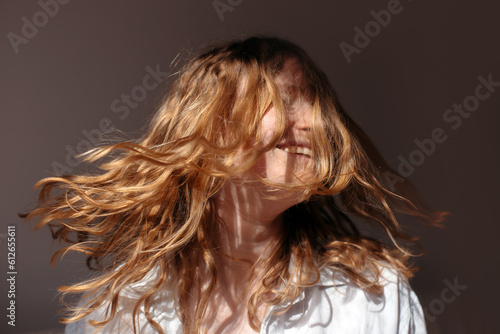 Happy blonde woman with disheveled hair photo