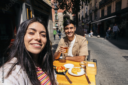 Couple eating spanish tapas and enjoying Madrid city photo