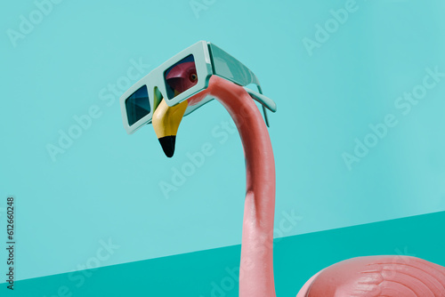 fake pink flamingo wearing a pair of sunglasses photo