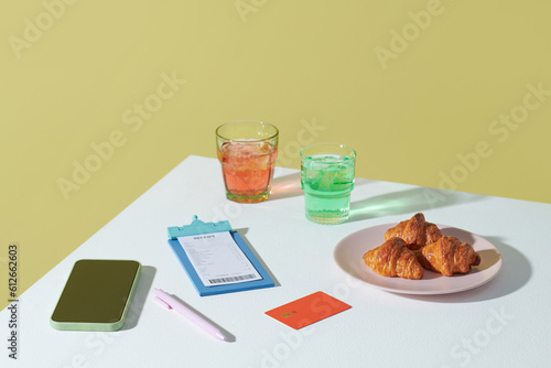 Croissant and soft drink payment by card in cafe photo