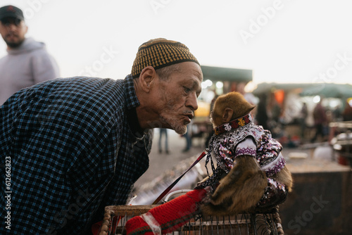 Moroccan man with monkey in a costume photo